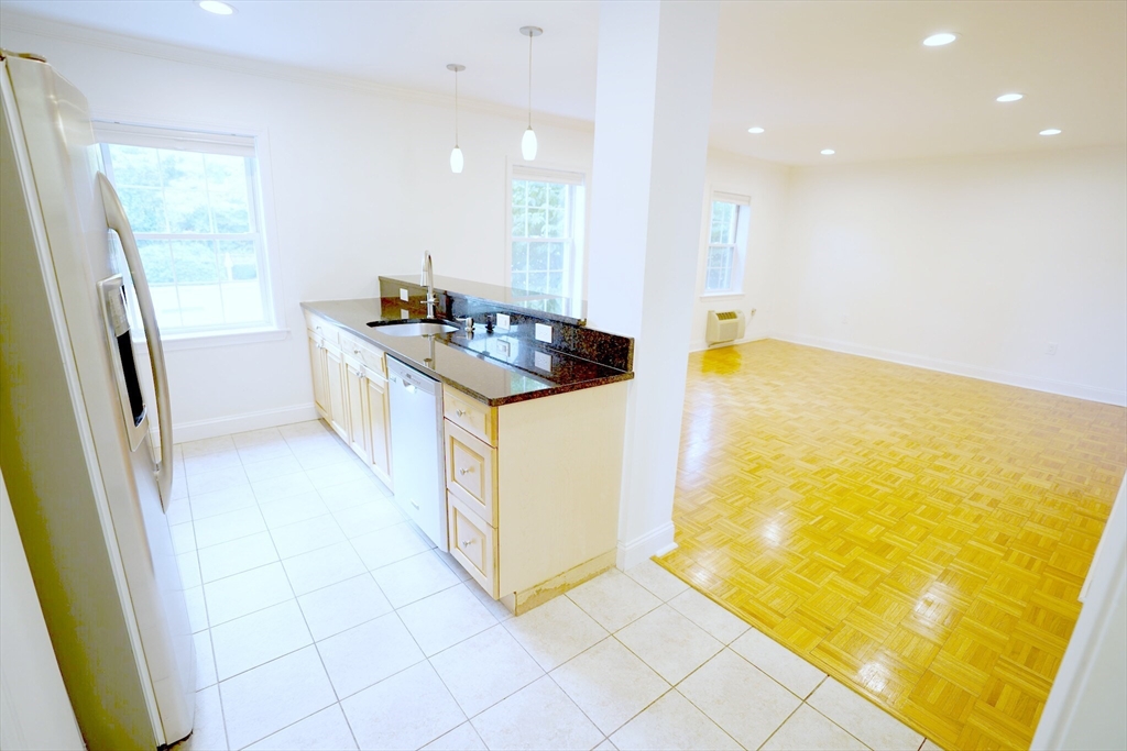 a kitchen with a sink a stove top oven a sink a counter top space and cabinets