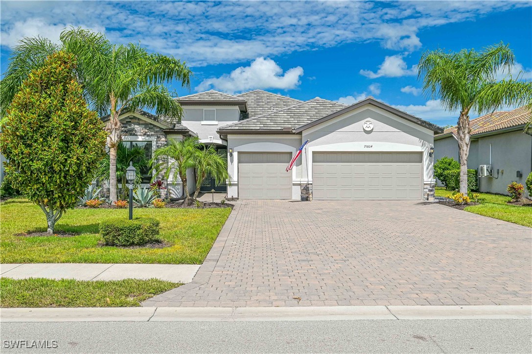 a front view of a house with a yard and garage