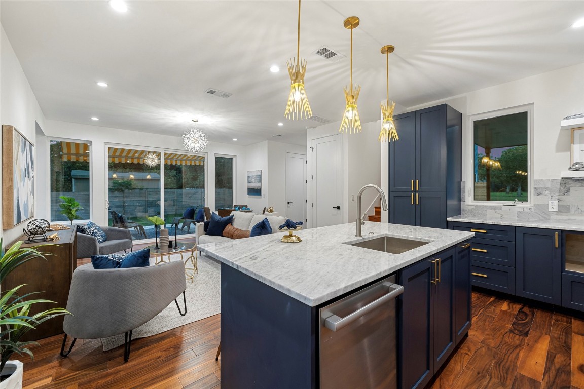 a open kitchen with a sink a counter top space and stainless steel appliances