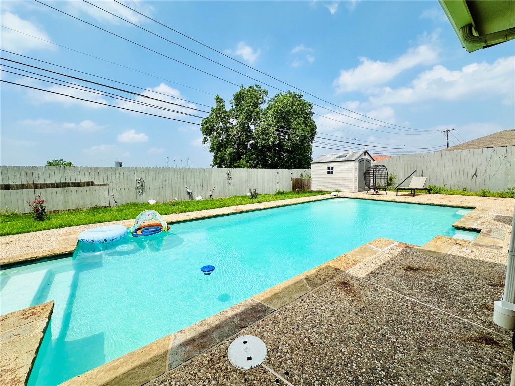 a view of a swimming pool with a yard