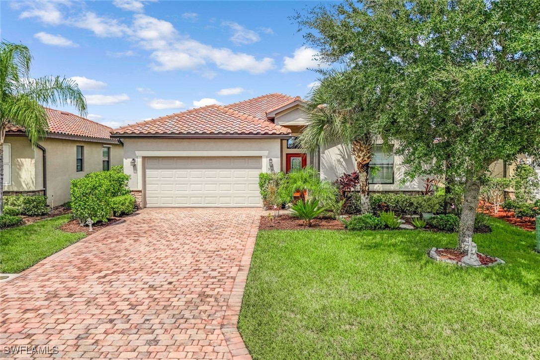 a front view of a house with a garden and plants