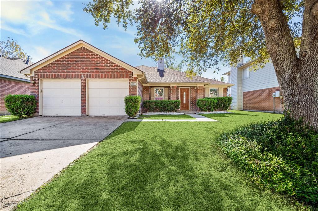 Charming single-story brick home with a two-car garage, well-maintained lawn, and mature tree in the front yard. Ideal for comfortable living in a serene neighborhood.