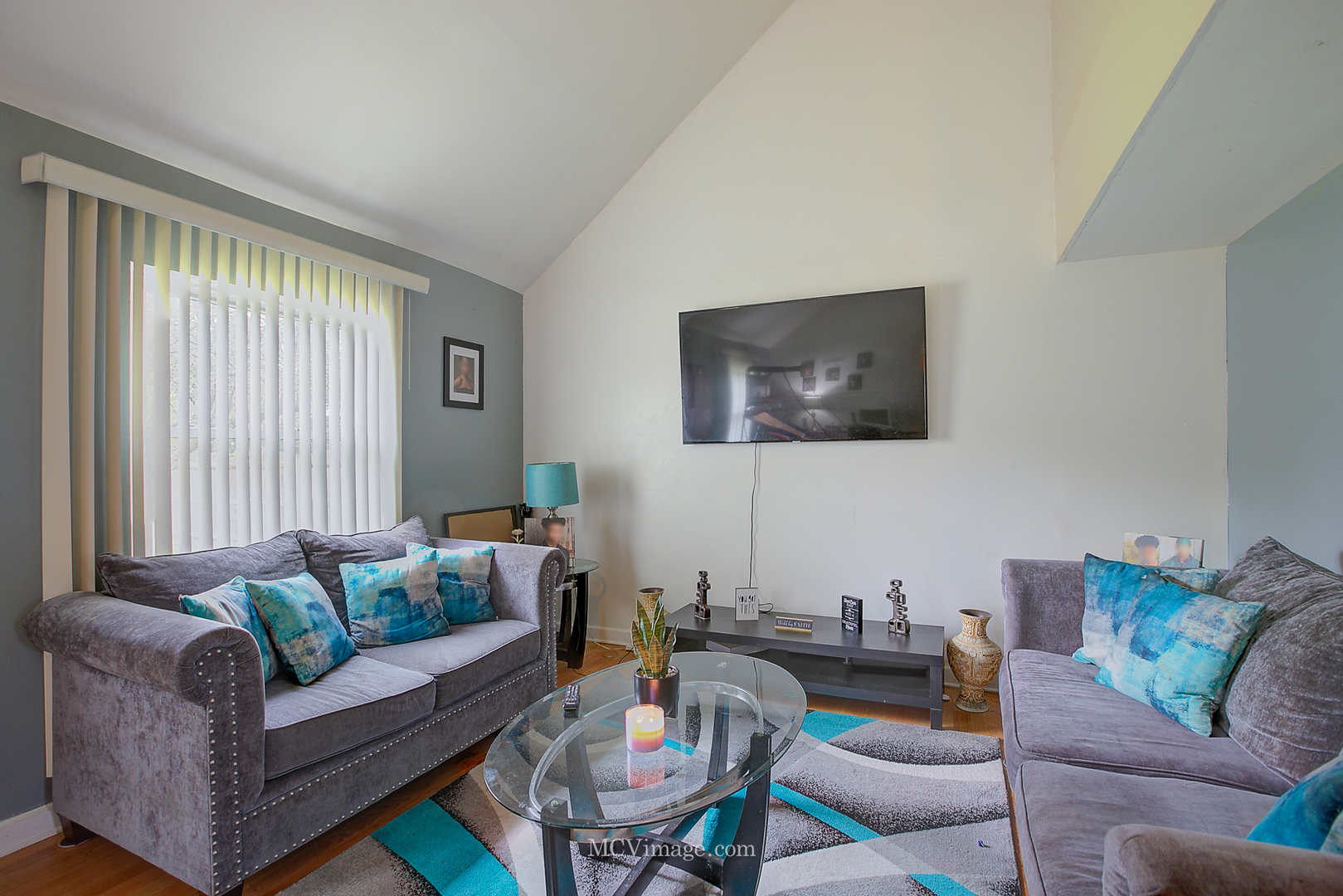 a living room with furniture and a flat screen tv