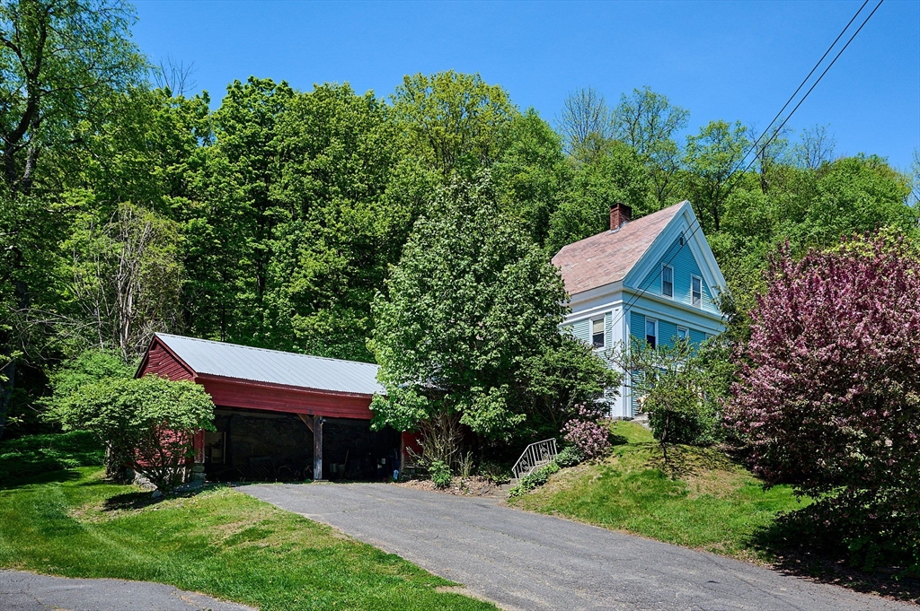 front view of a house with a tree