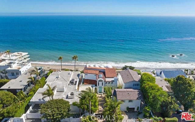 an aerial view of a house with a ocean view