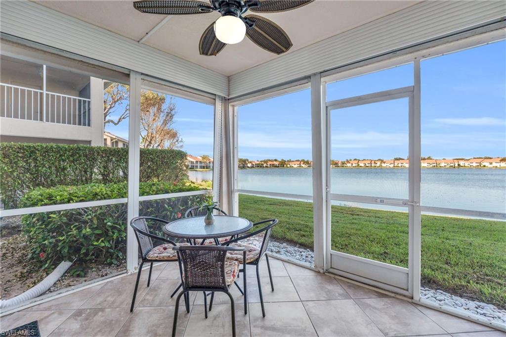 a view of a porch with furniture and backyard