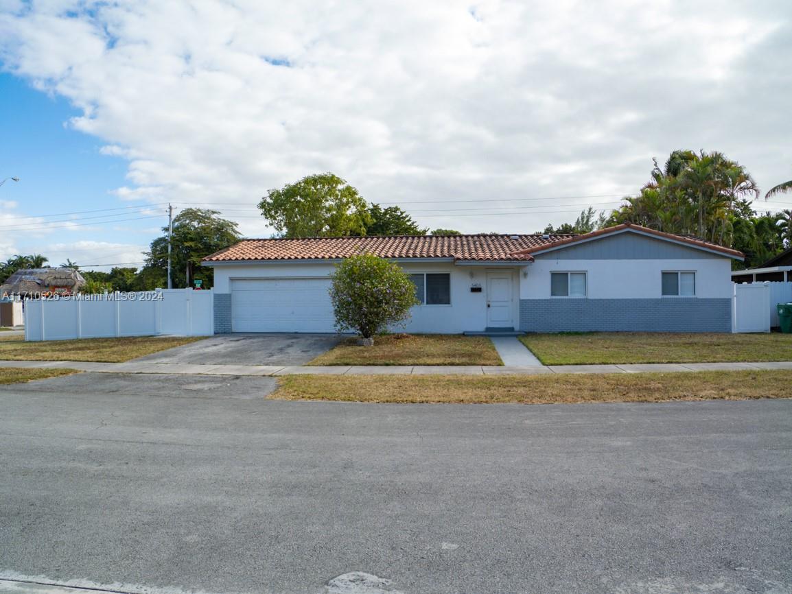 a view of a house with a swimming pool and a yard