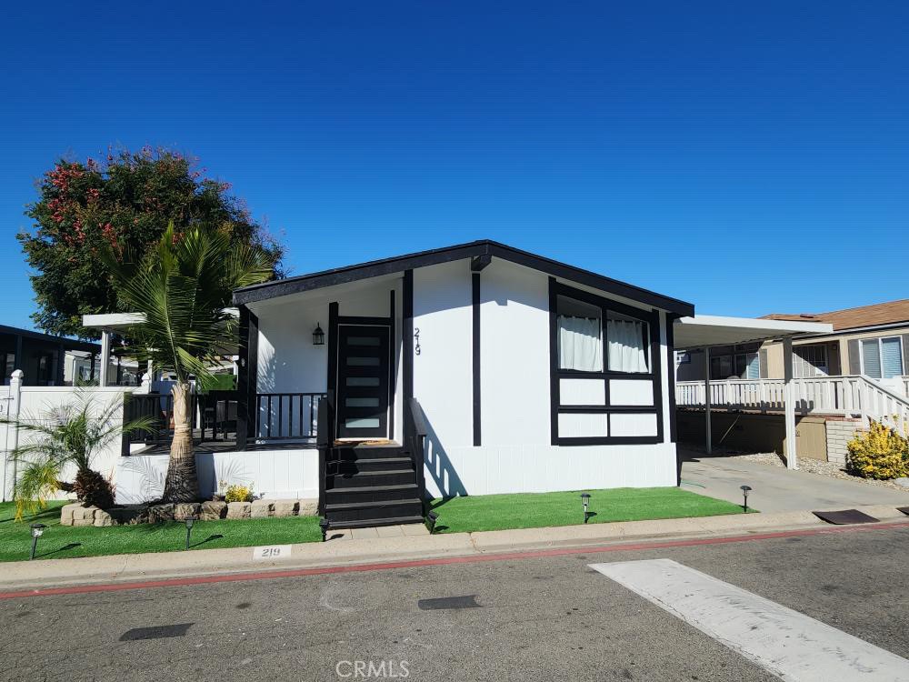 a view of a house with a yard and garage