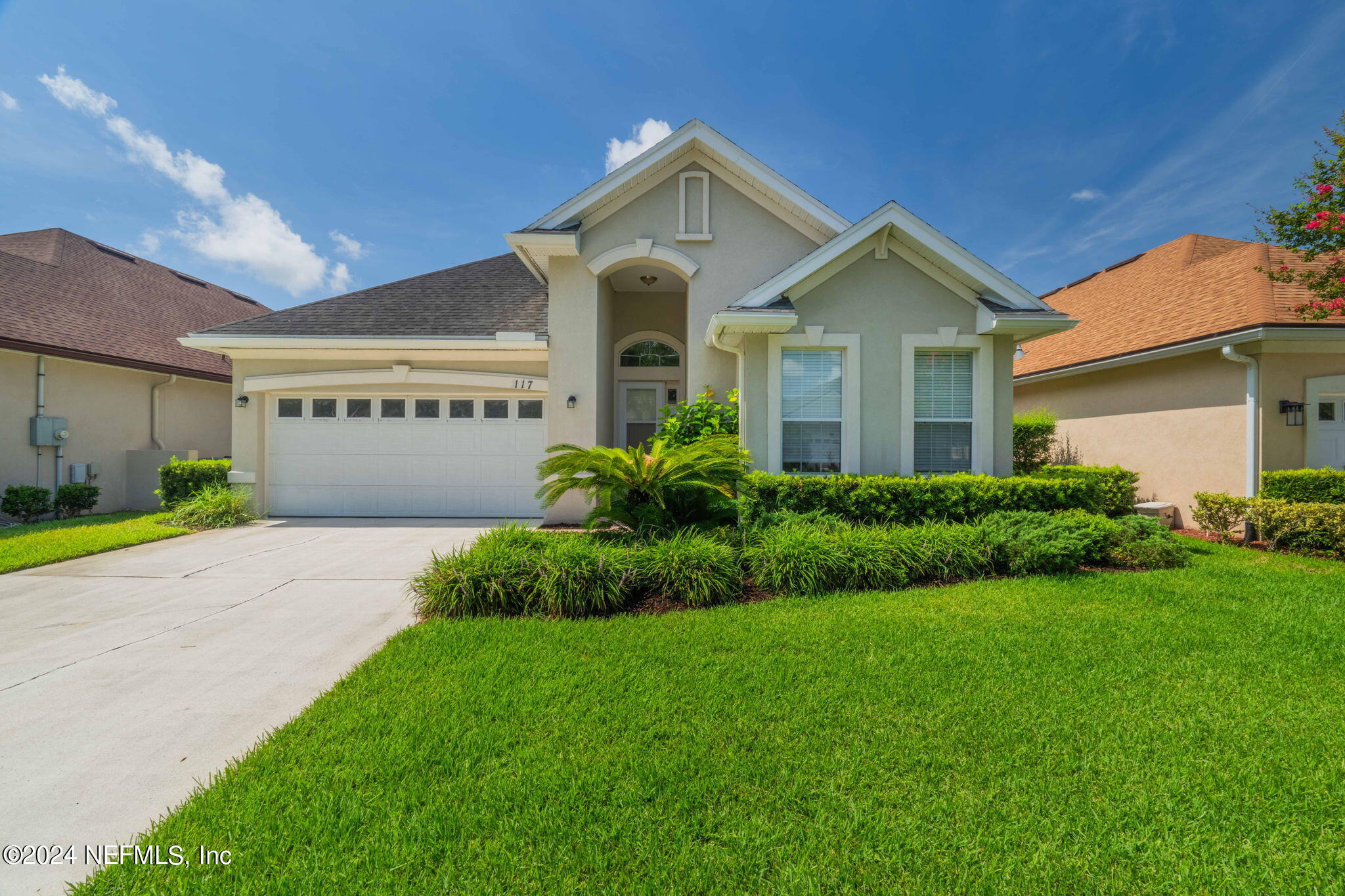 a front view of a house with garden