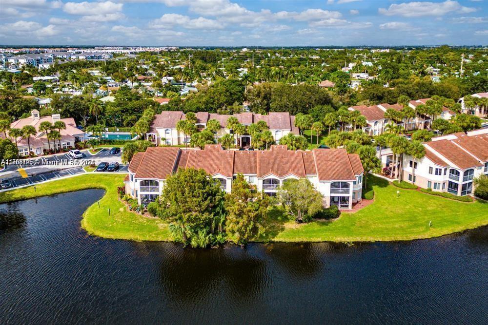 an aerial view of residential houses with outdoor space and swimming pool