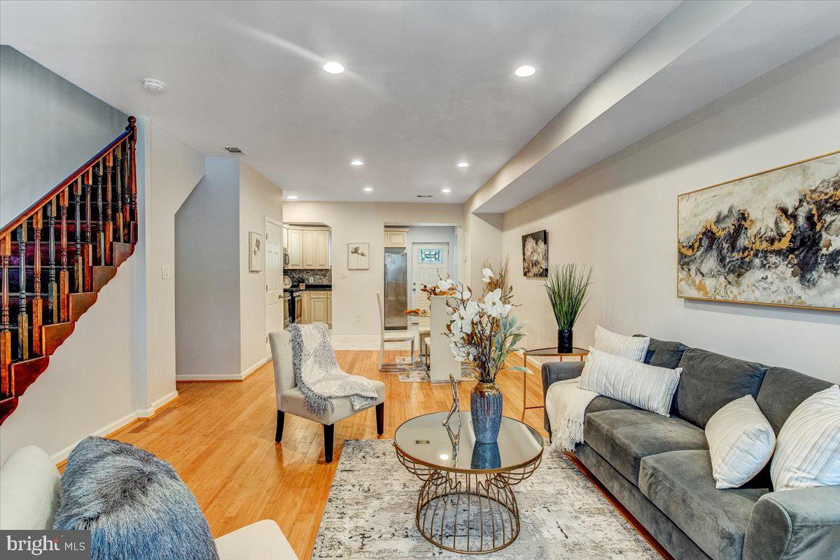 a living room with furniture and wooden floor