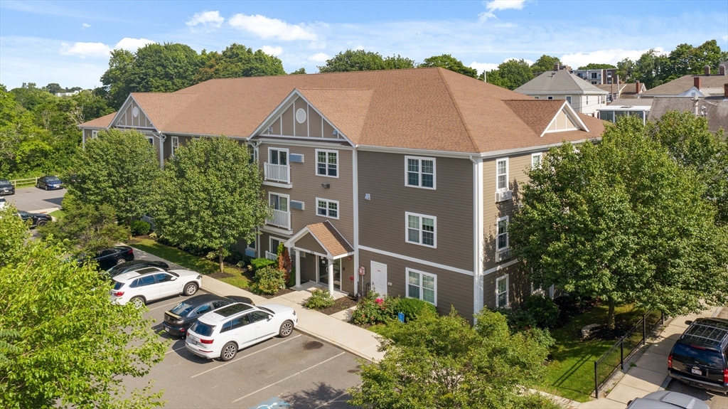 an aerial view of multiple houses with yard