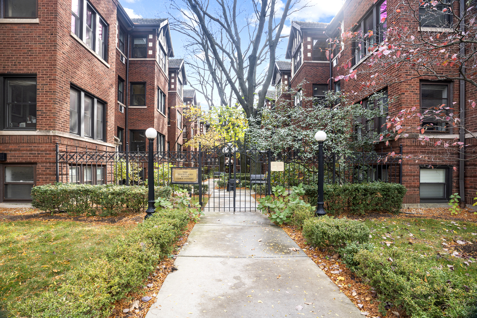 a view of a brick building next to a yard