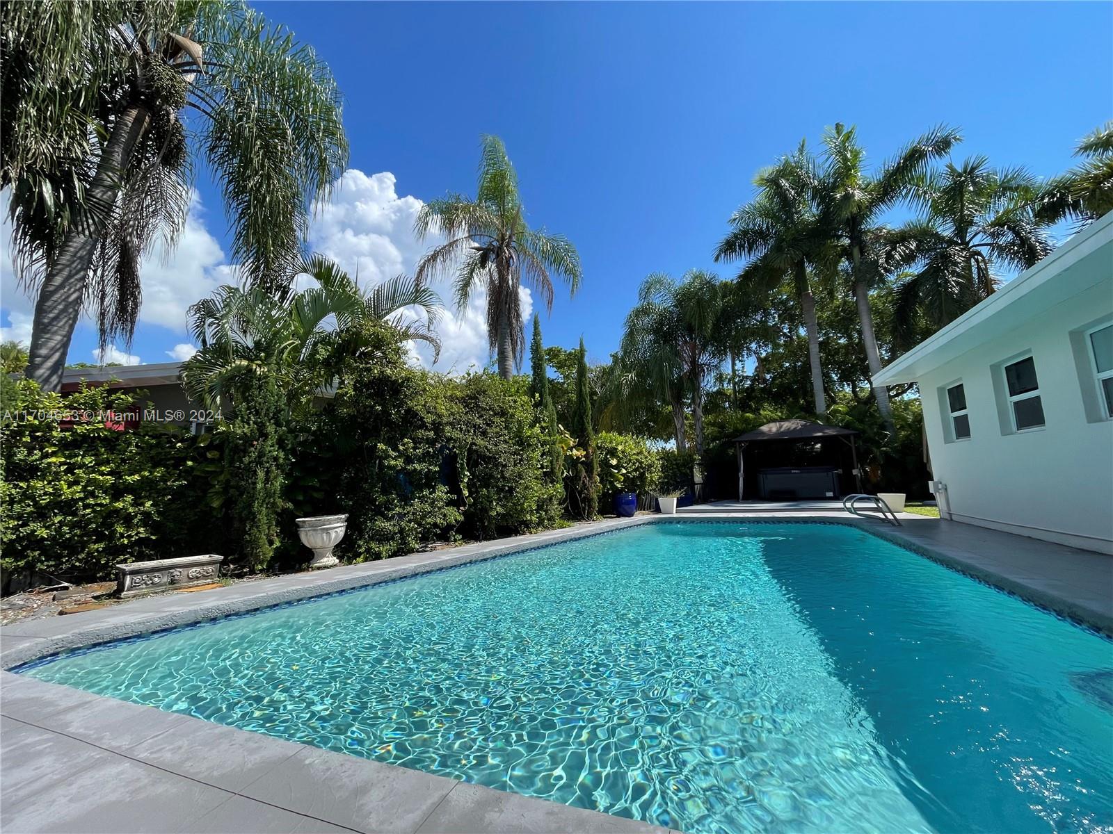 a view of a backyard with plants and a patio