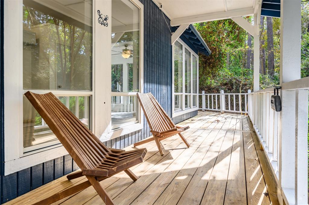 a view of balcony with wooden floor and outdoor seating