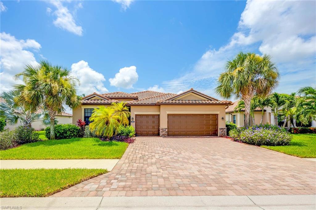 a front view of a house with a yard and garage