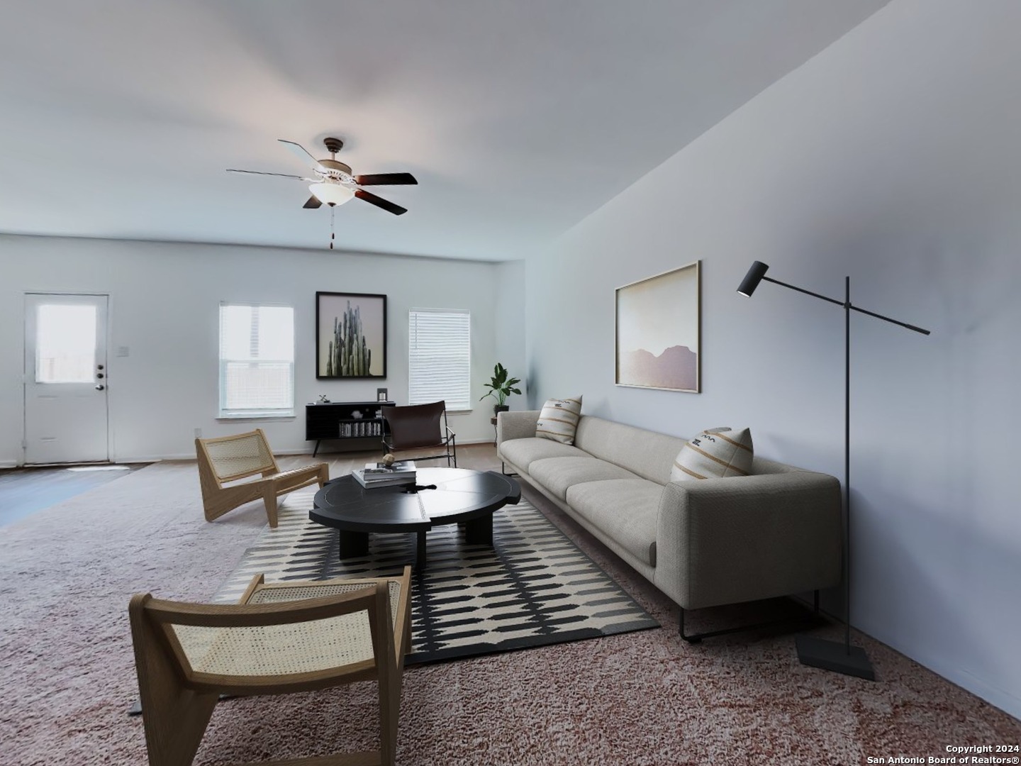 a living room with furniture a rug and a chandelier