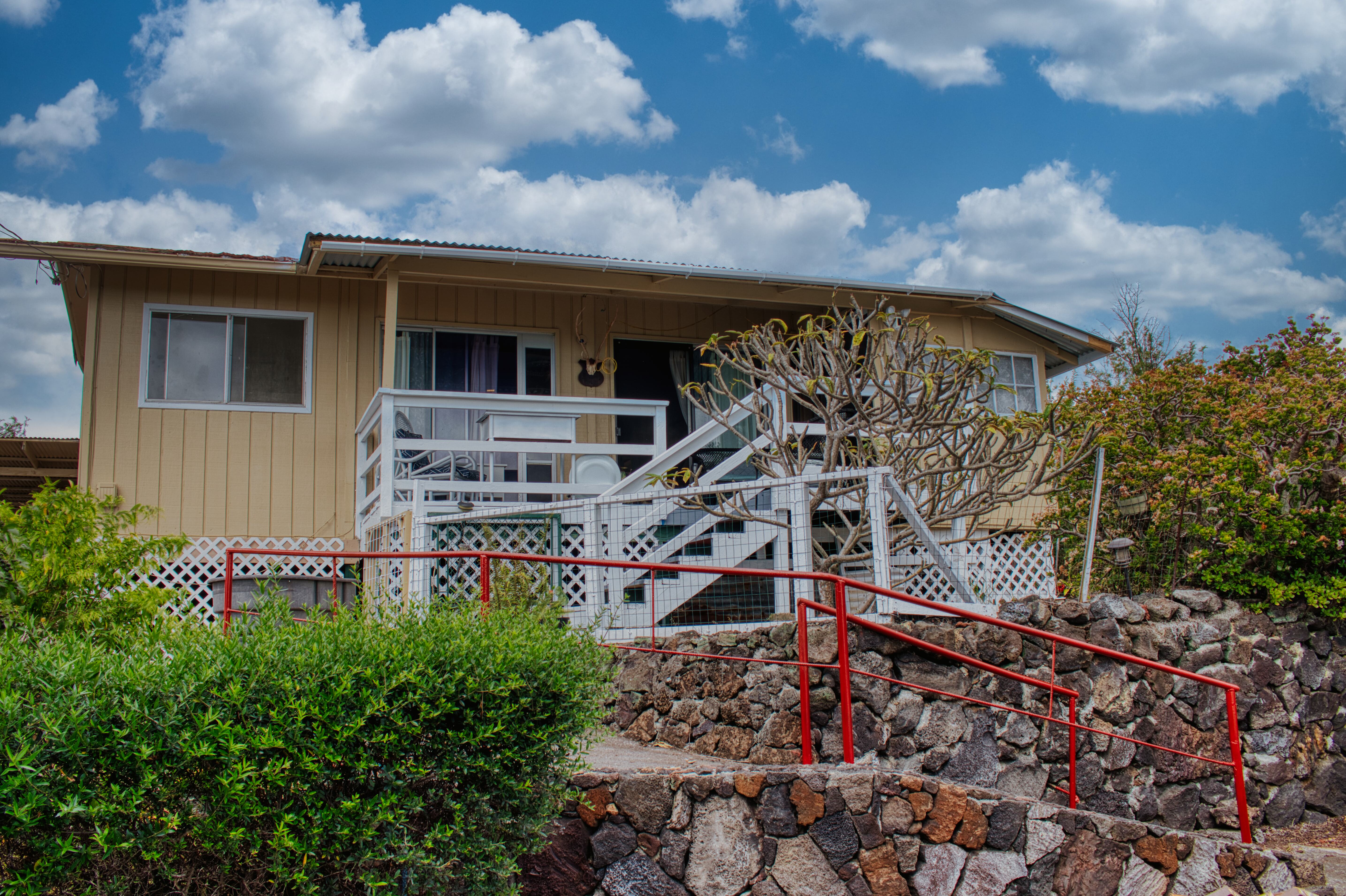 a view of a house with a wooden fence