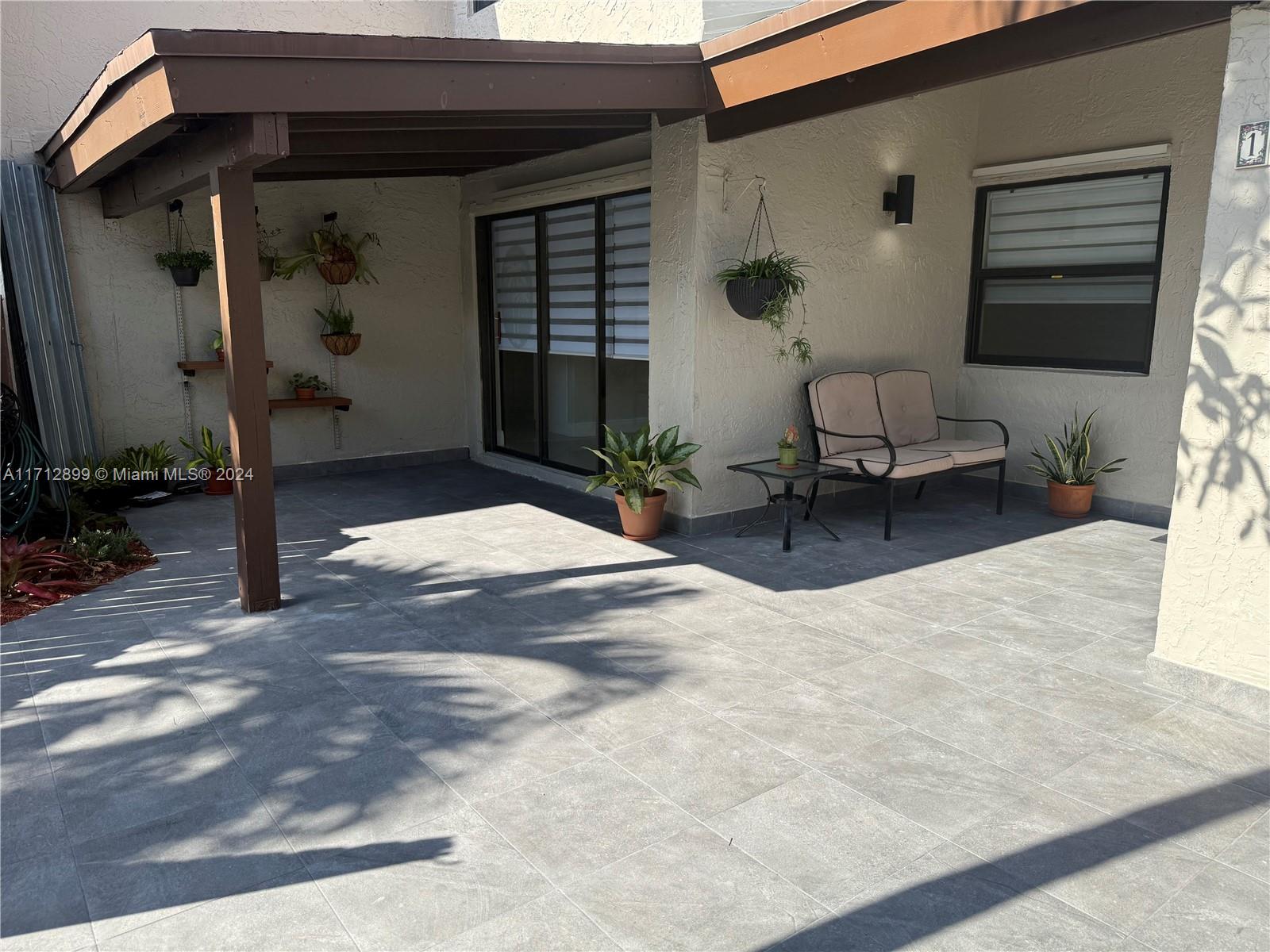 a backyard of a house with outdoor seating