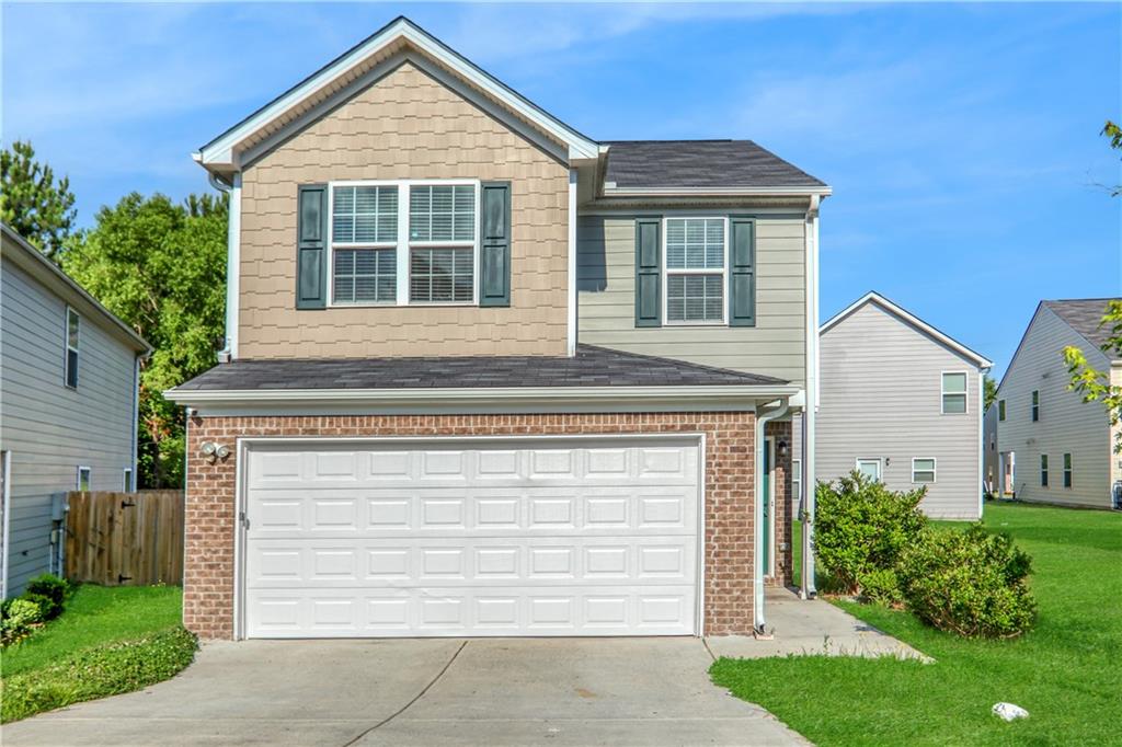 a front view of a house with a yard