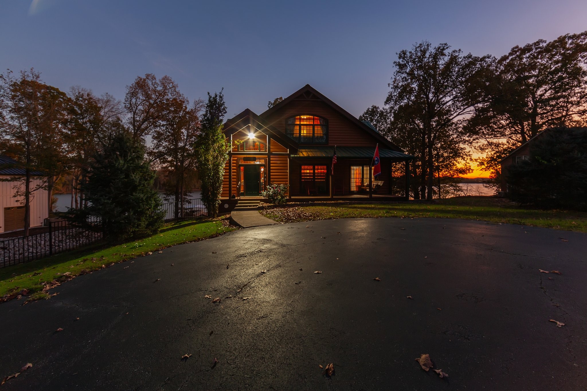 a front view of a house with yard and green space