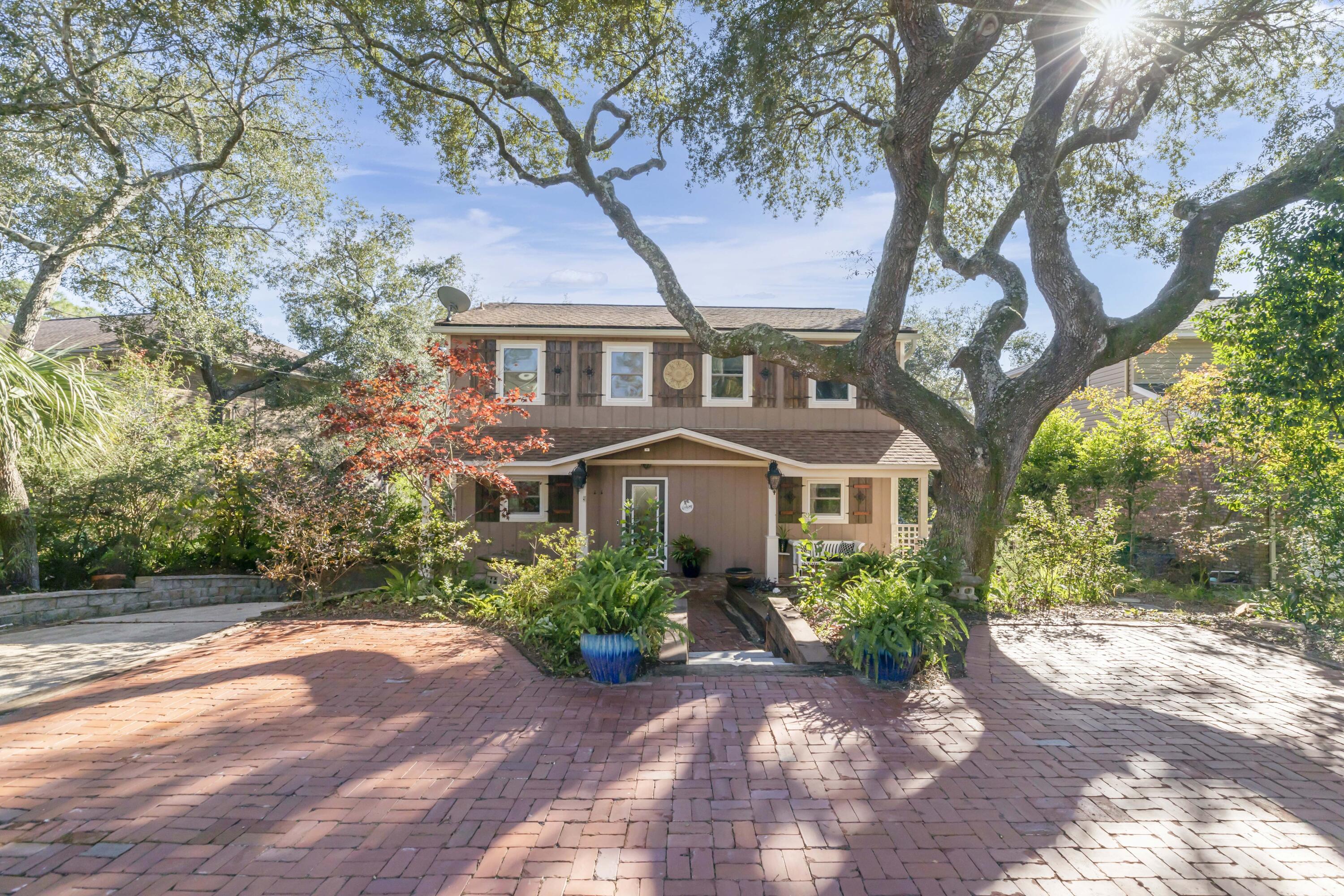 a front view of a house with a garden