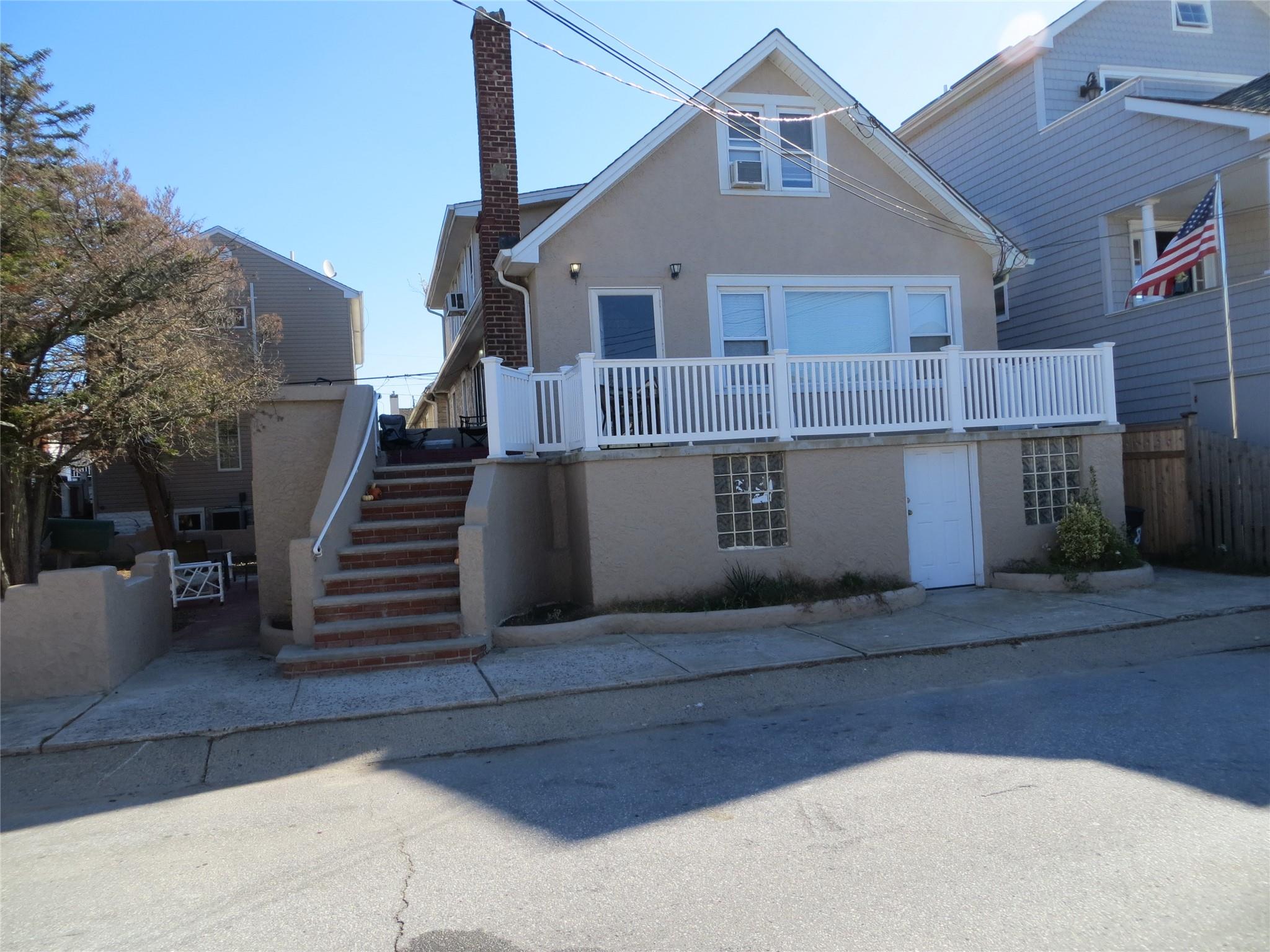 a front view of a house with wooden stairs