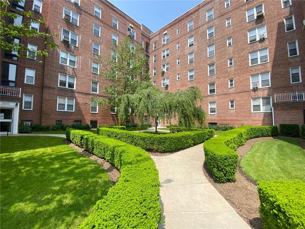 a view of a building with a yard