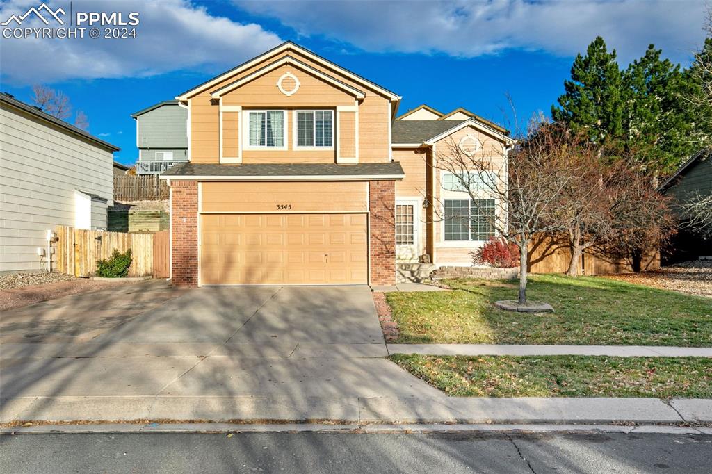 Front facade with a garage and a front yard