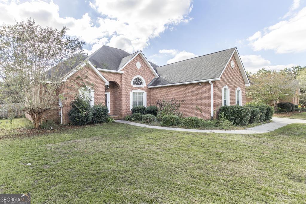 a front view of a house with garden