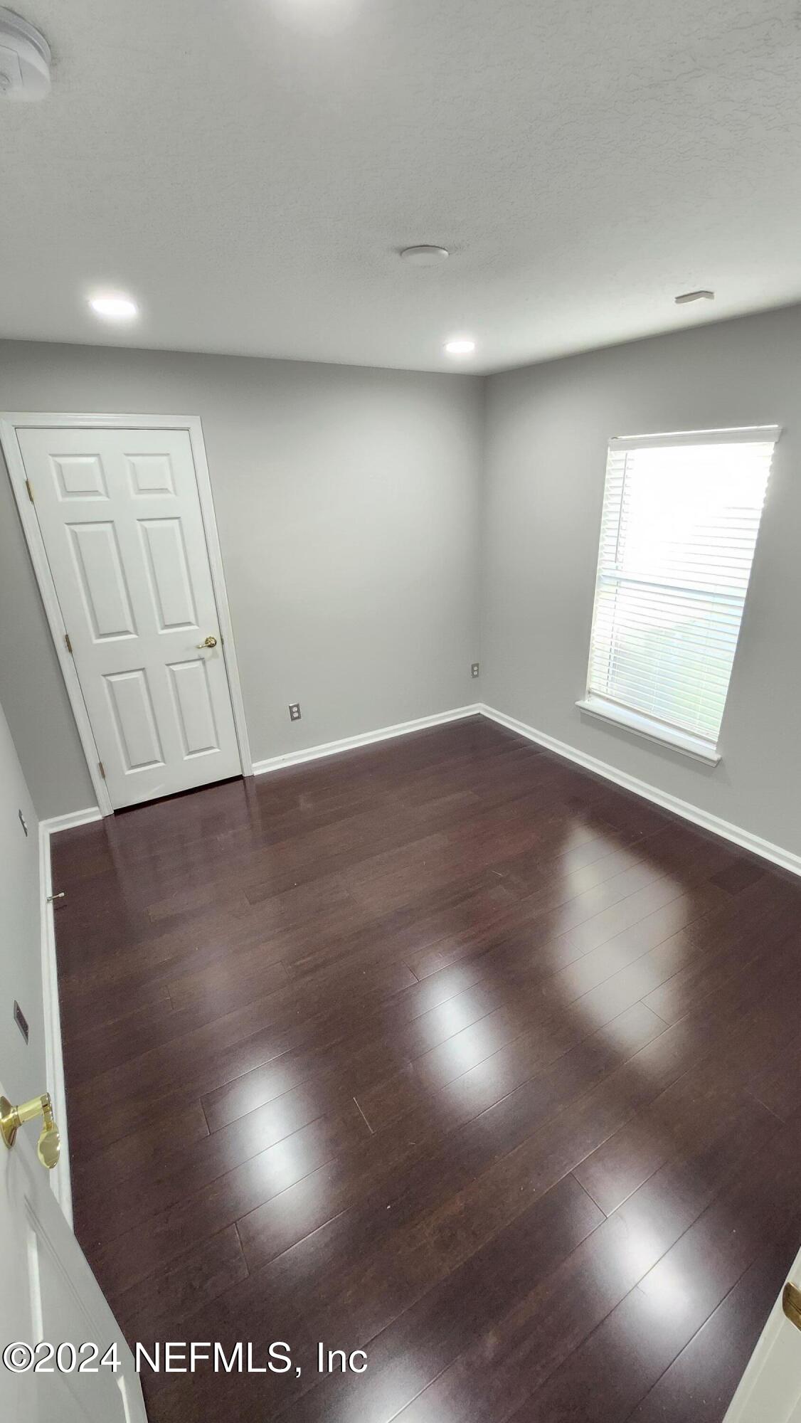 an empty room with wooden floor