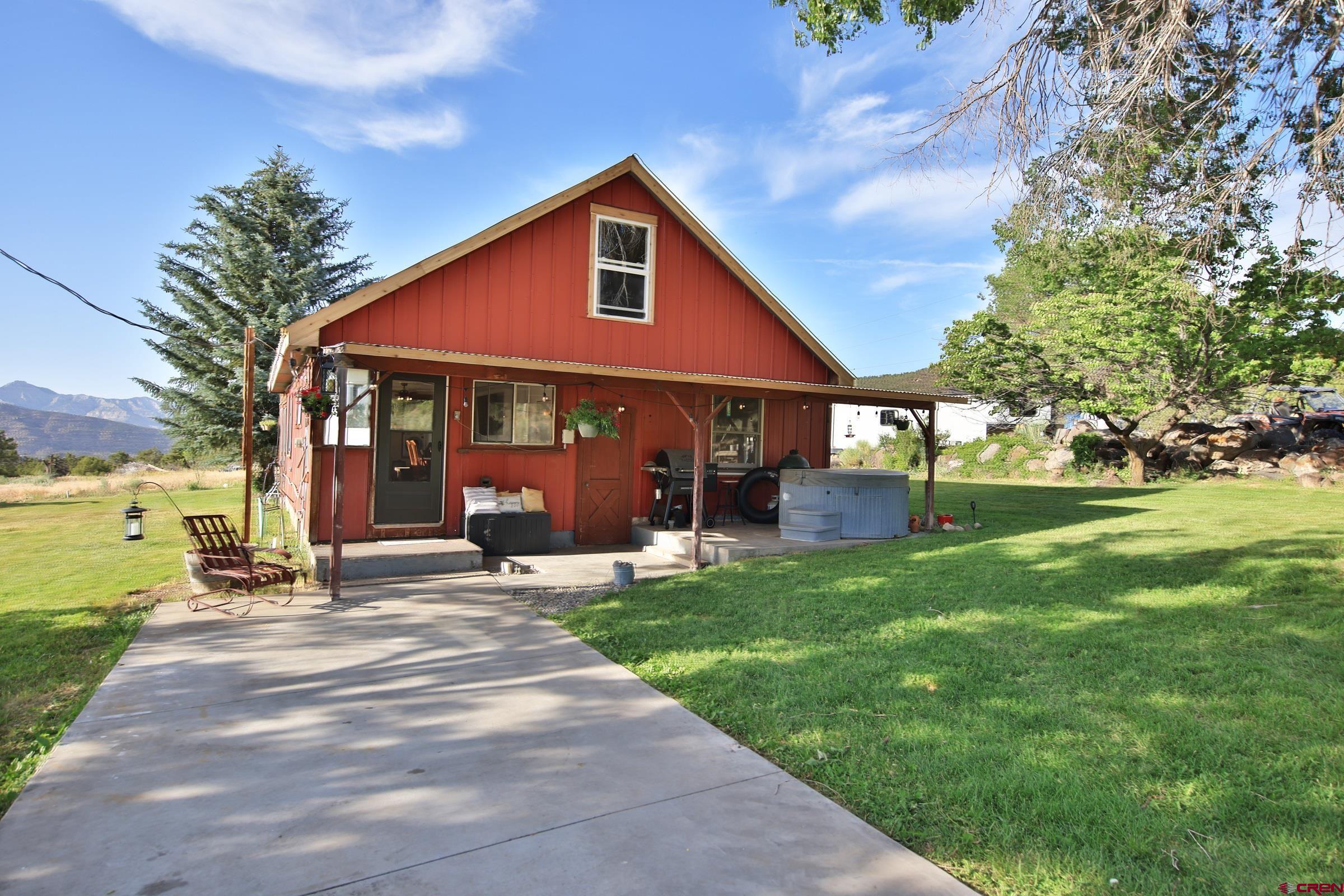 a view of a house with a yard and sitting area