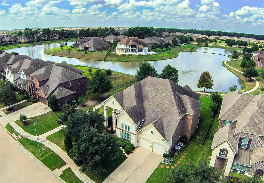 an aerial view of a house with outdoor space and lake view