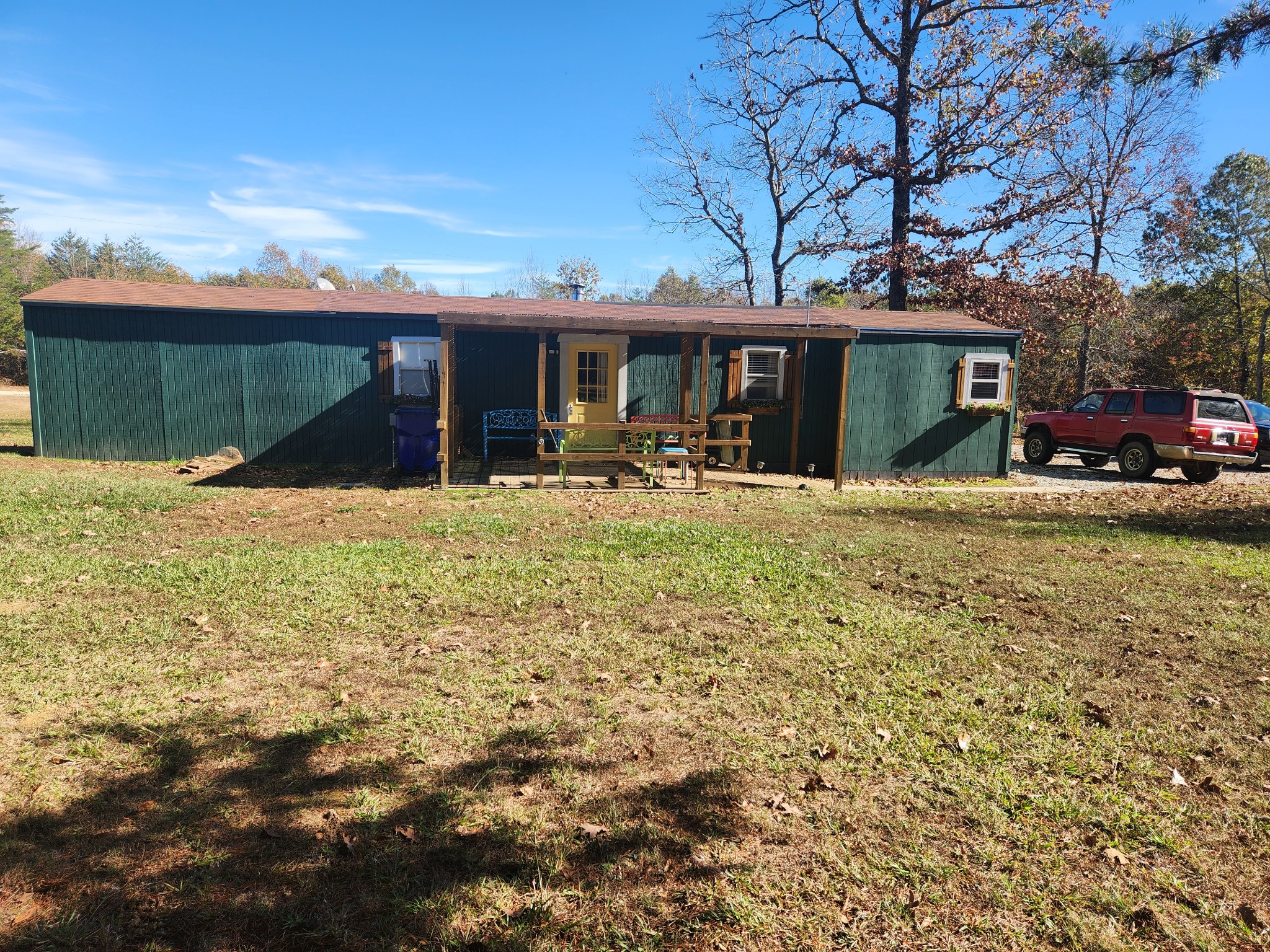 a front view of house with yard and car parked