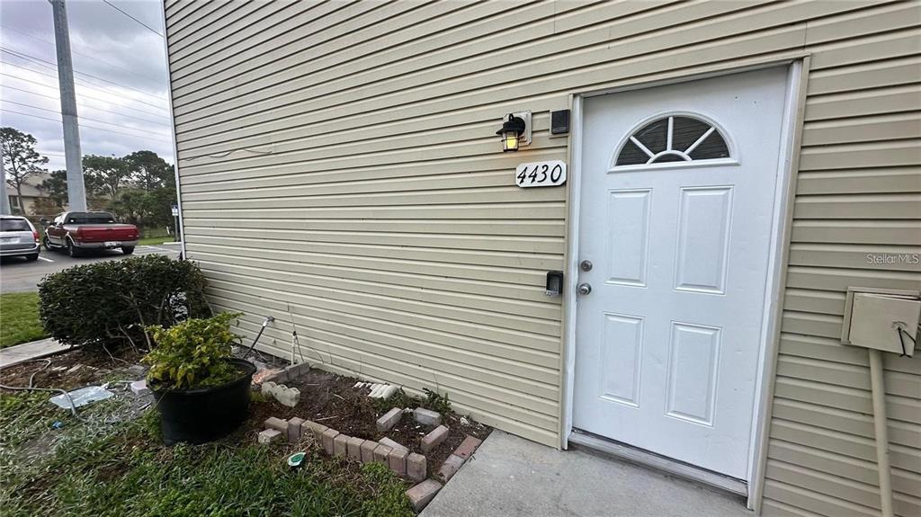 a view of a house with a potted plant and a window