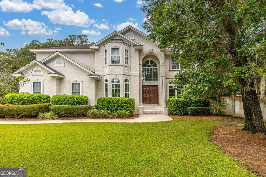 a front view of a house with a yard