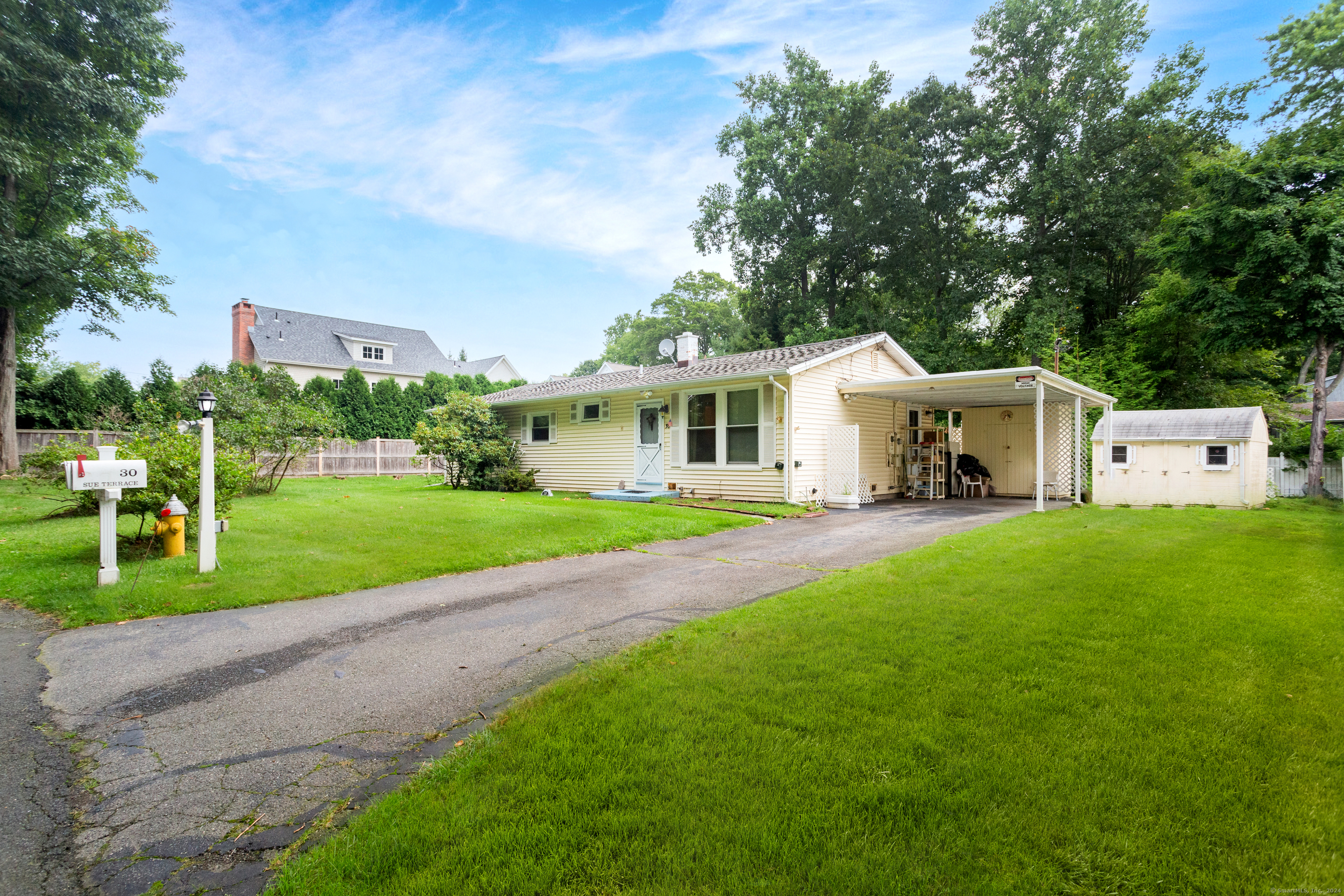 a view of house with yard and green space