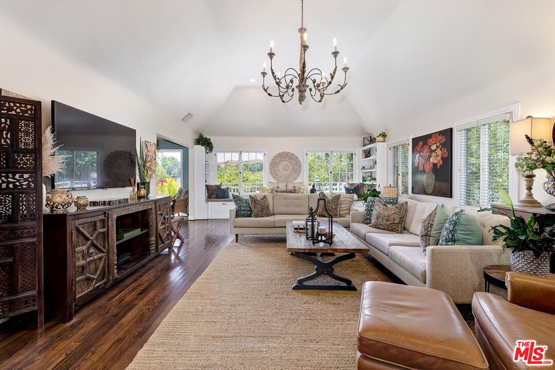 a living room with furniture fireplace and flat screen tv