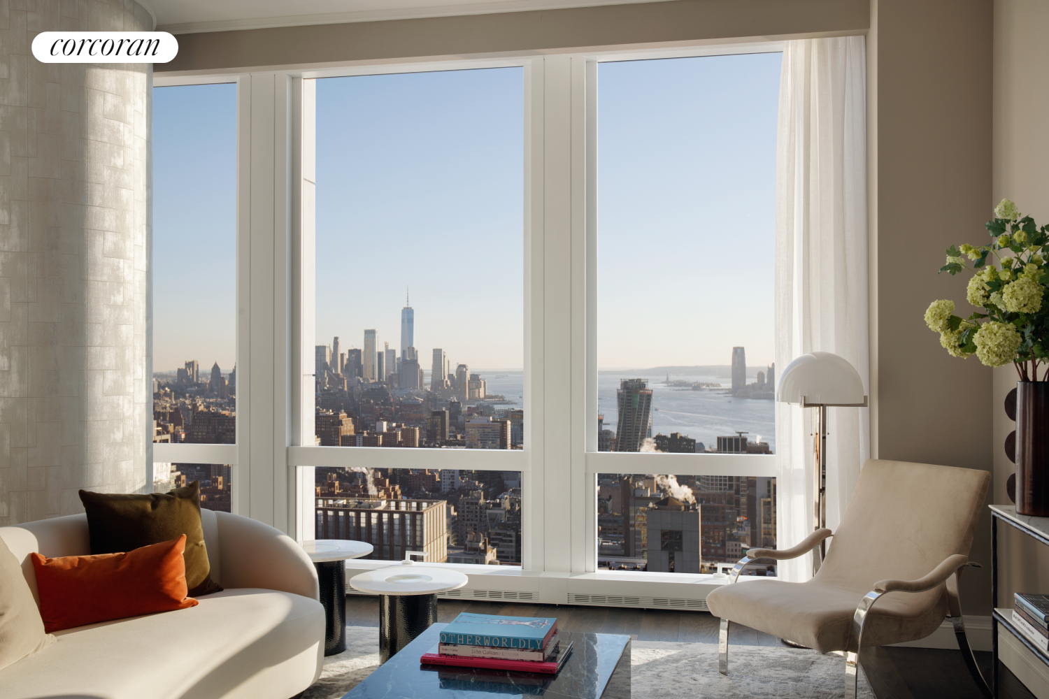 a living room with furniture and a floor to ceiling window