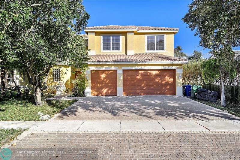 a view of a house with a yard and garage