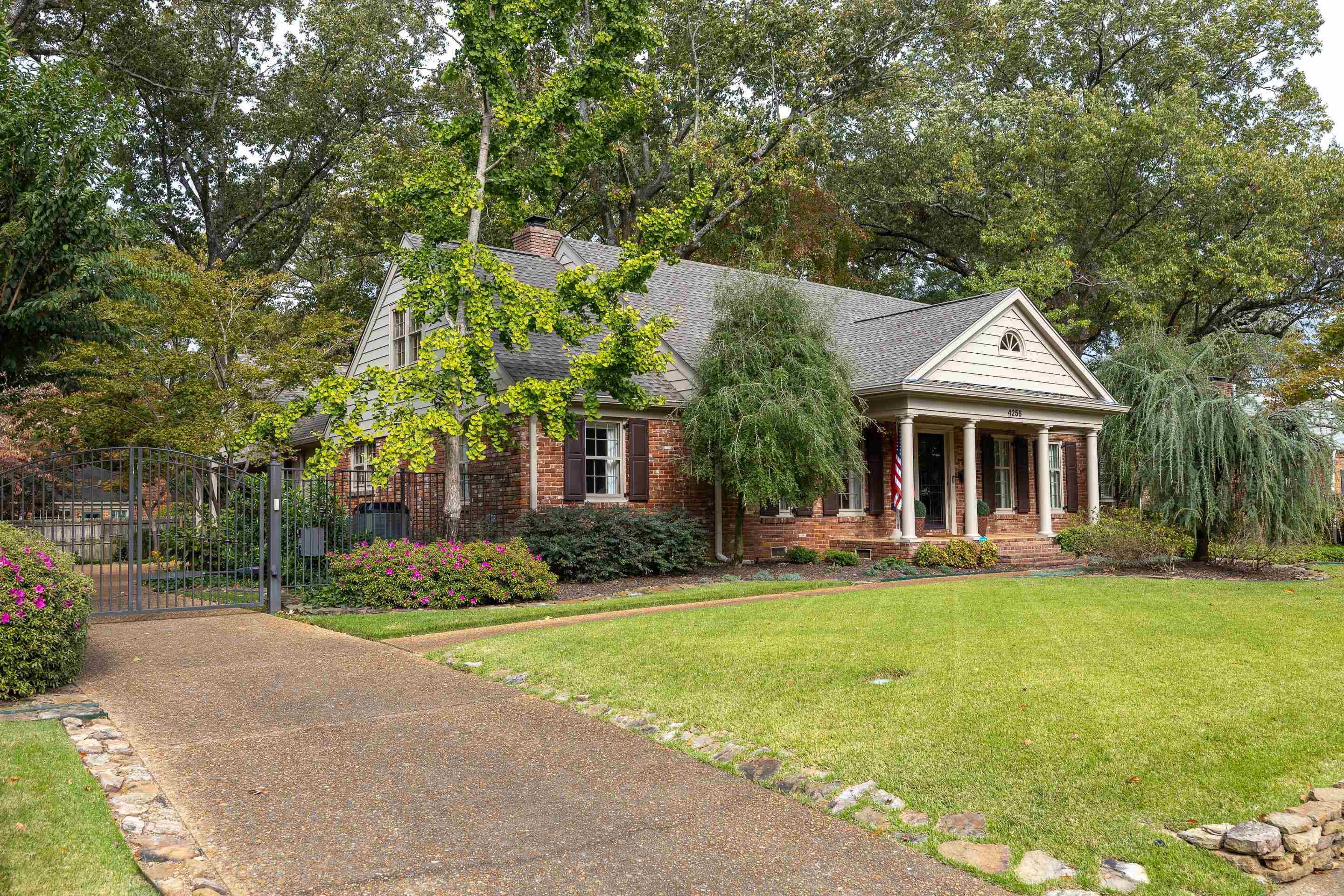 View of front facade with a front lawn and covered porch