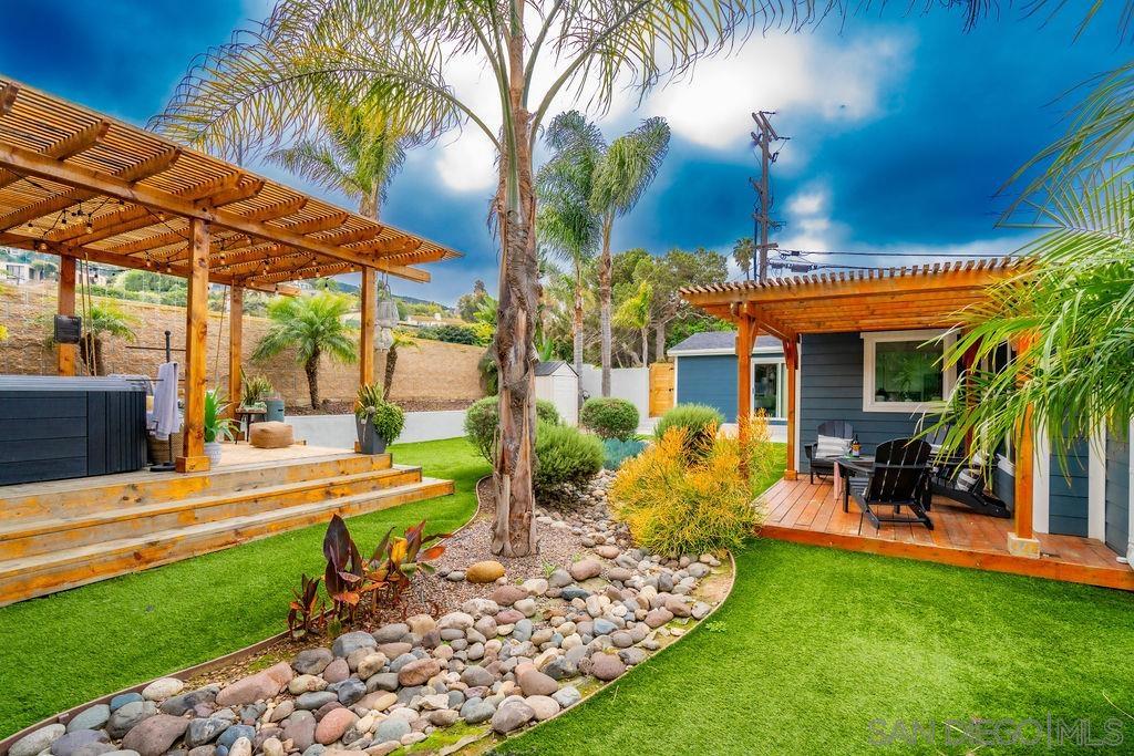 a view of a house with backyard porch and sitting area