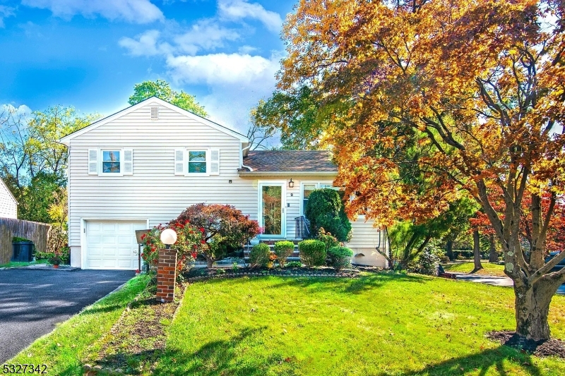 a front view of a house with a yard garage and outdoor seating