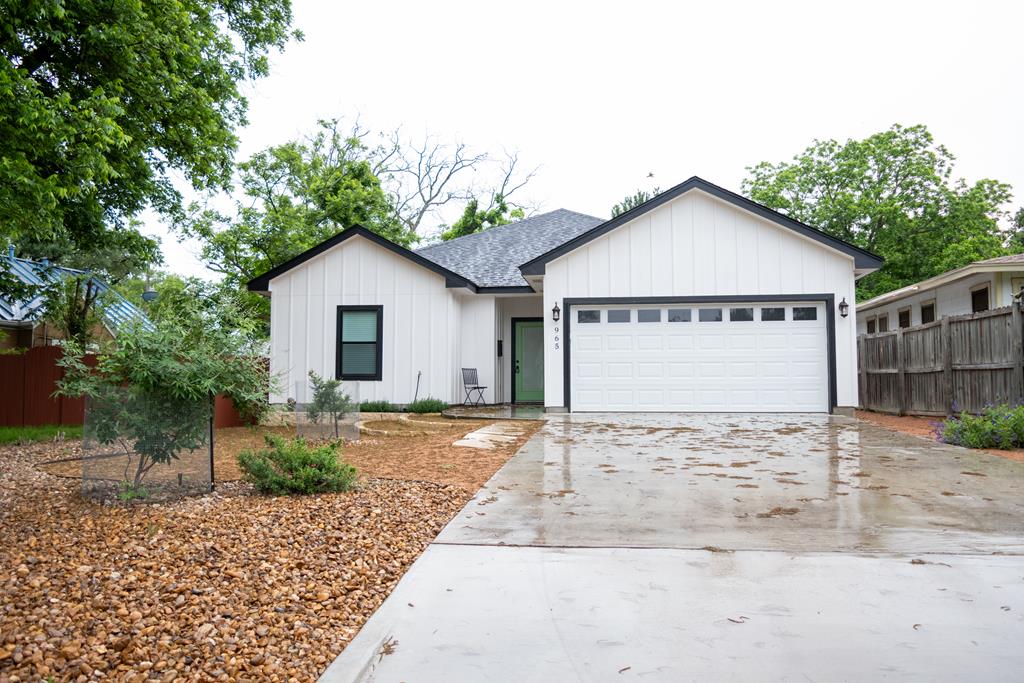 a view of front of a house with a yard and garage