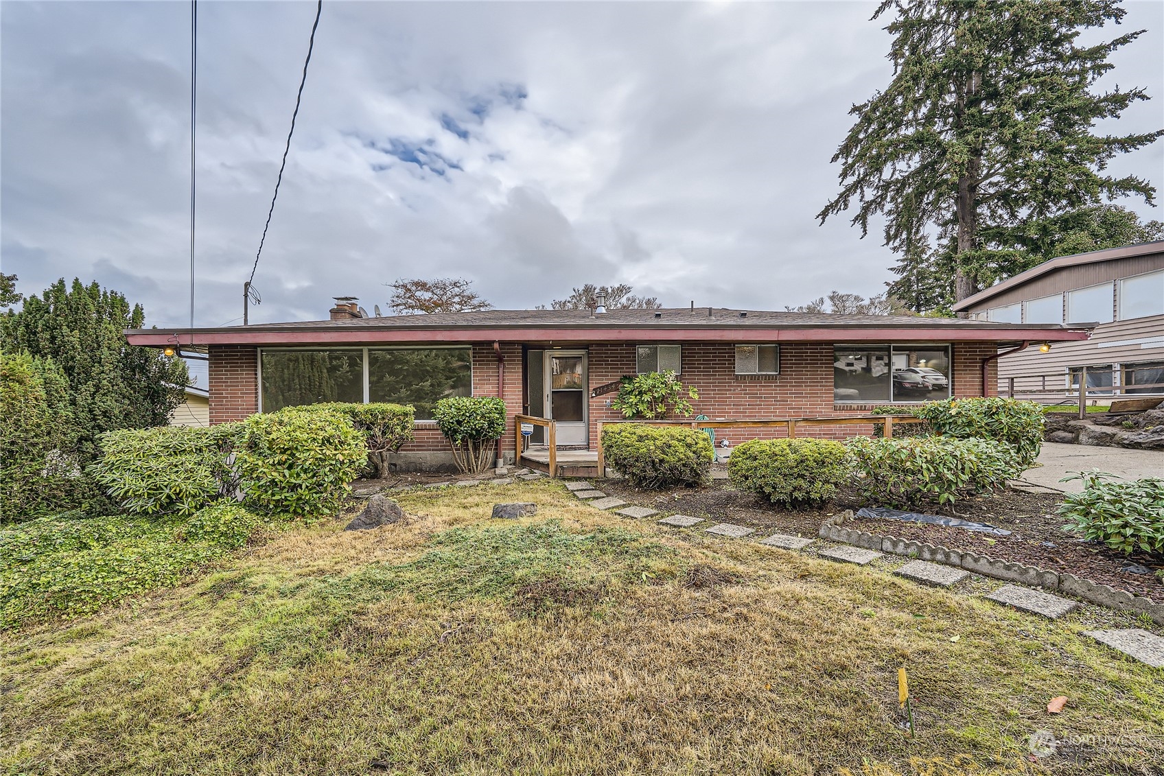 a view of a house with a big yard and potted plants