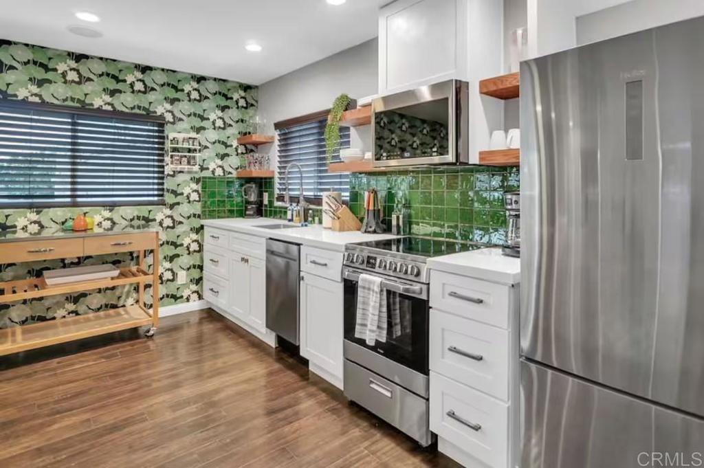 a kitchen with stainless steel appliances a stove and a refrigerator