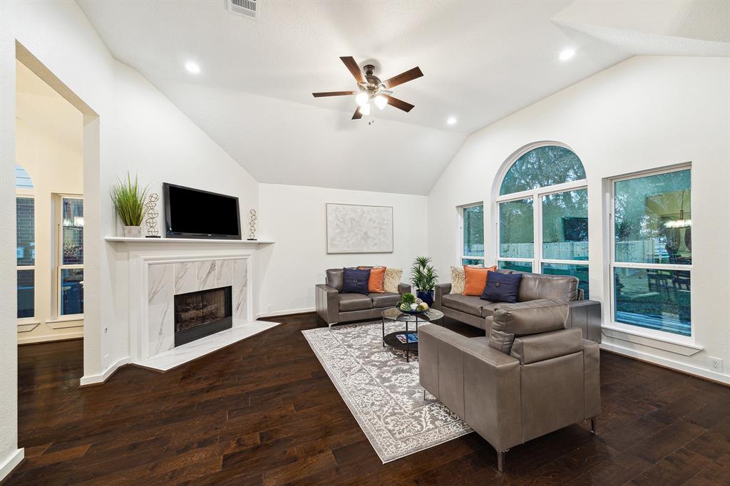 a living room with fireplace furniture and a flat screen tv