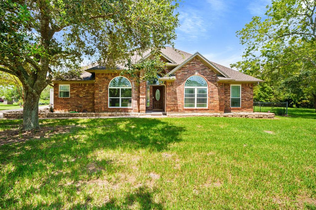 a front view of house with yard and green space