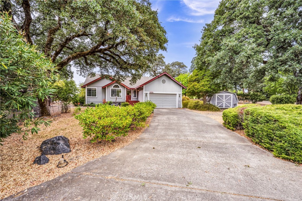 a front view of a house with a yard and a garage