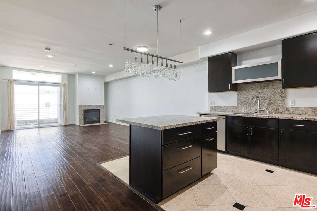 a kitchen with a refrigerator and a stove top oven